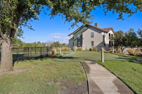 a golf course in front of a house at The Fairways at Star Ranch, Hutto, 78634