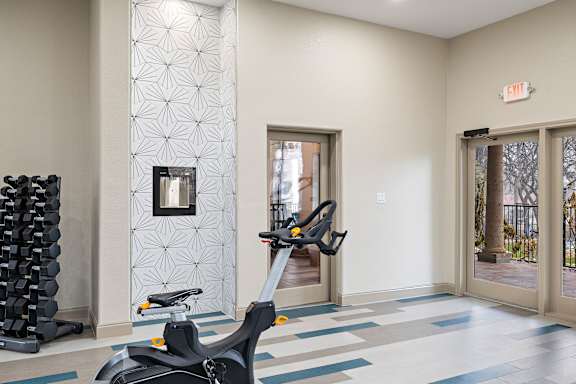 Fitness room with spin bike at Waters Edge Apartment Homes, Georgetown, Texas