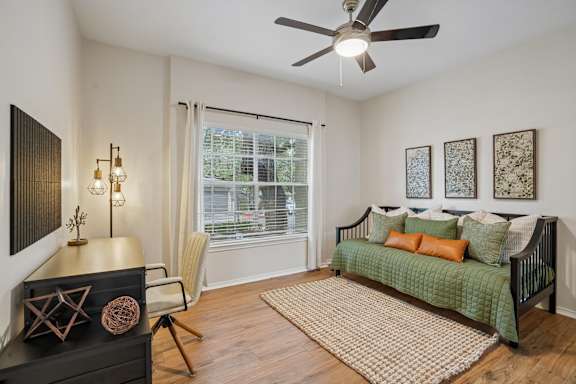 Guest room with daybed and ceiling fan at Legends on the Green Apartments, San Antonio, 78232