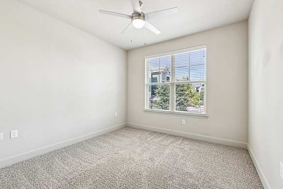 A room with a ceiling fan and carpeted floor.at North Creek, Hutto, TX, 78634