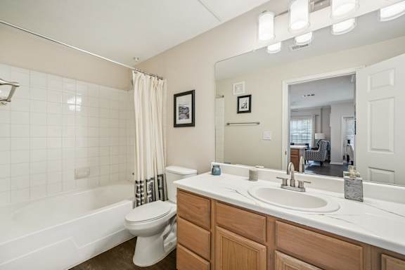 A white bathroom with a toilet, sink, and tub.
