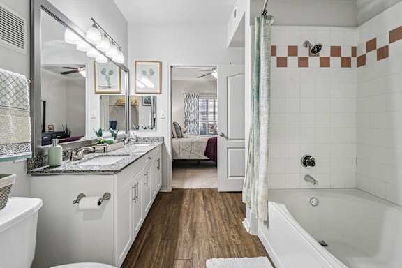 A bathroom with a white tub and a white sink.