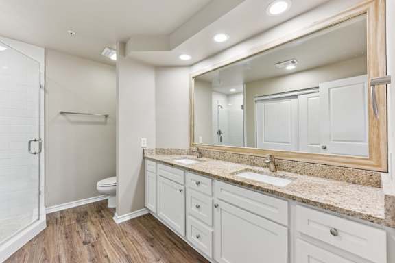 Bathroom with a marble countertop at Waters Edge Apartment Homes, Georgetown, Texas