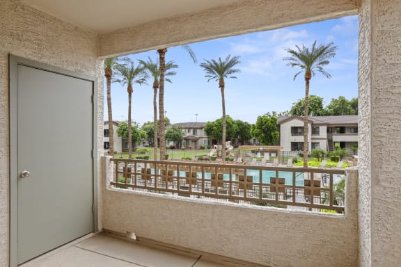 a view of the pool from a balcony at the preserve at great pond apartments in windsor  at Adiamo Palm Valley, Goodyear, AZ