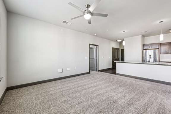 A room with a ceiling fan and carpeted floor.at North Creek, Hutto, TX