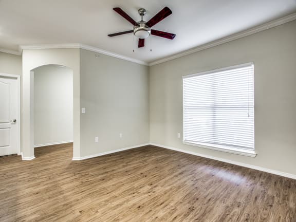 a living room with hardwood floors and a ceiling fan at The Canyons Apartments, Fort Worth, TX, 76116