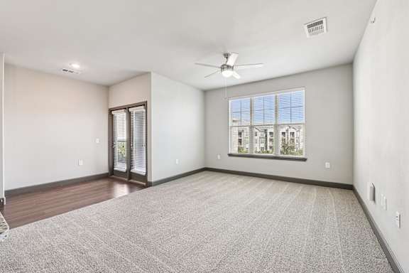 A room with a carpeted floor and a ceiling fan.at North Creek, Hutto, TX, 78634