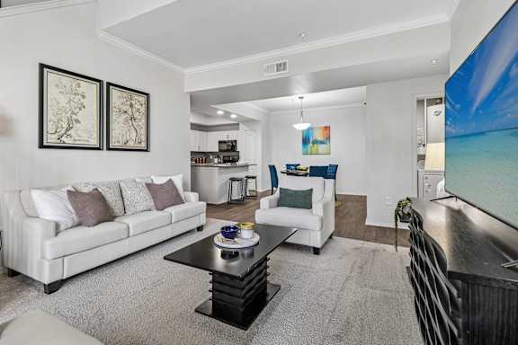 A living room with a white couch and a coffee table.