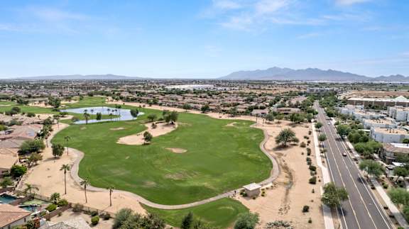 an aerial view of a golf course with a city in the background  at Adiamo Palm Valley, Arizona