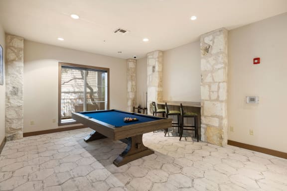 a game room with a pool table and a bar at Lakeline East Apartments, Cedar Park, 78613