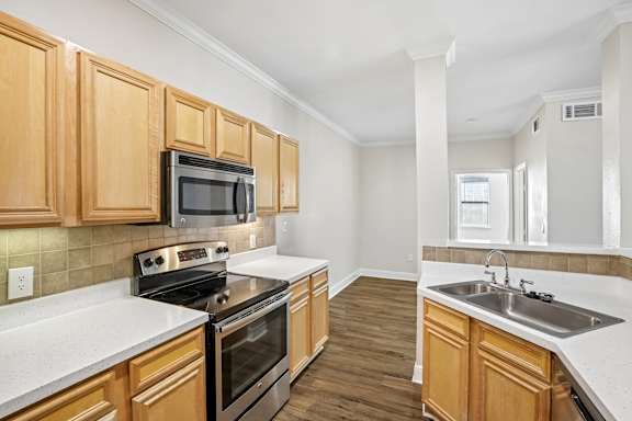 A kitchen with wooden cabinets and a black stove top oven.