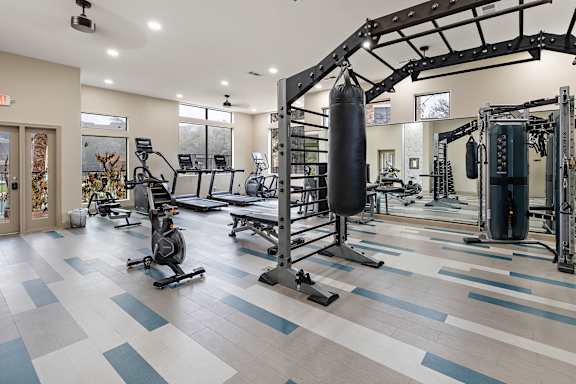 A gym with a punching bag at Waters Edge Apartment Homes, Georgetown