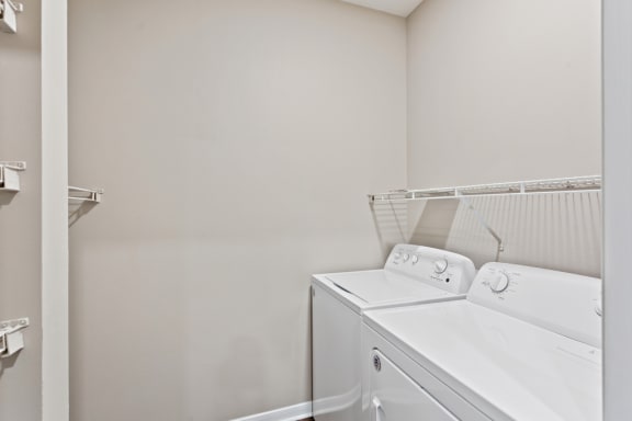 a white laundry room with a washer and dryer