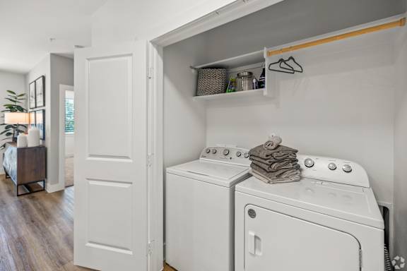 A laundry room with a washer and dryer stacked on top of each other.