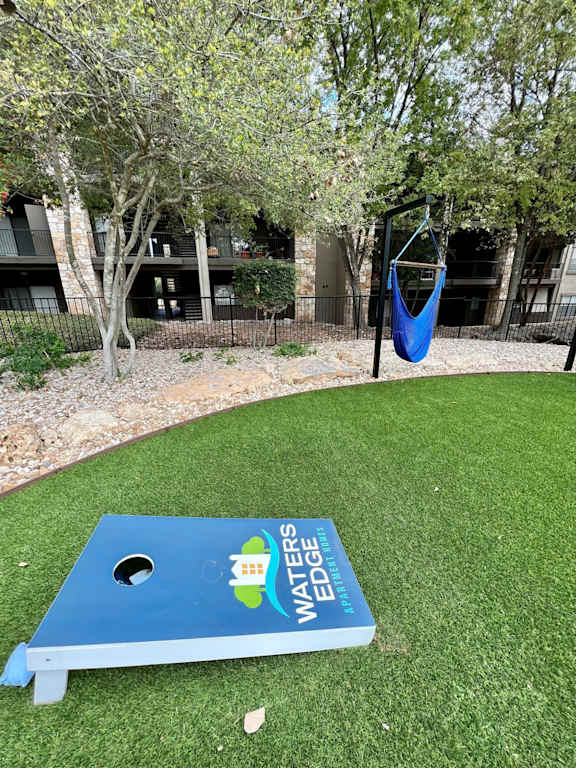 Cornhole and hammock at Waters Edge Apartment Homes, Georgetown, 78626