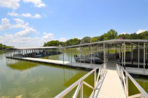 a dock at a lake with boats docked at a marina at The Legends at Eagle Mountain Lake, Fort Worth, TX