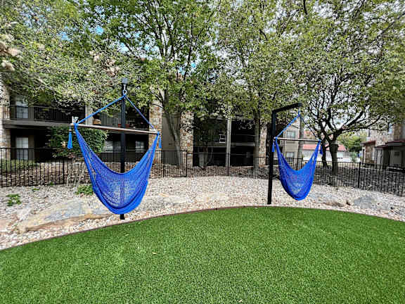 Community cornhole and hammock area at Waters Edge Apartment Homes, Georgetown, TX