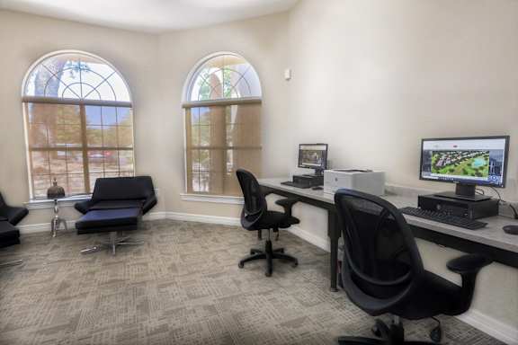an office with two windows and a desk with a computer at TalaVera Apartments, San Antonio, TX