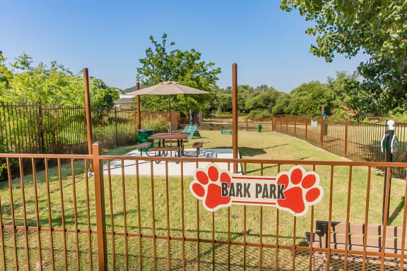 a park with a fence and a sign for bark park at The Legends at Eagle Mountain Lake, Texas, 76179
