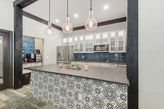 A kitchen with a black and white patterned island.