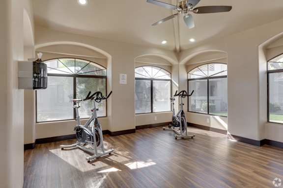 A room with a wooden floor and a ceiling fan. at San Montego Apartments, Mesa, 85206