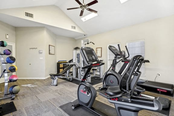 the gym has plenty of exercise equipment and a ceiling fan at The Legends at Eagle Mountain Lake, Fort Worth, 76179
