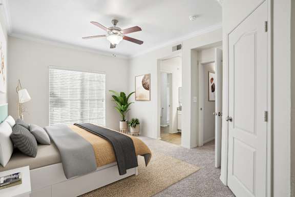 A bedroom with a bed, a ceiling fan, and a rug.