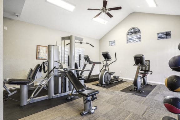 the fitness room has cardio equipment and a ceiling fan at The Legends at Eagle Mountain Lake, Fort Worth