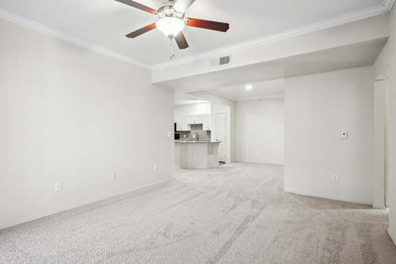 A room with a ceiling fan and carpeted floor.