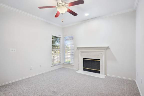 A room with a fireplace and a ceiling fan.