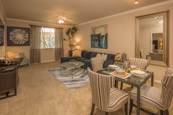 a living room and dining room with a table and chairs at Loreto & Palacio Apartments, Las Vegas