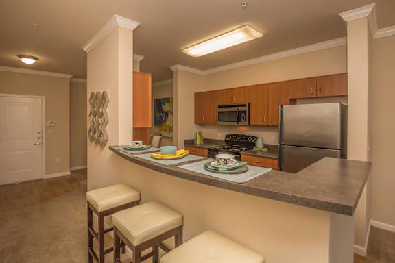 a kitchen with a long counter top and a sink at Loreto & Palacio Apartments, Las Vegas, Nevada
