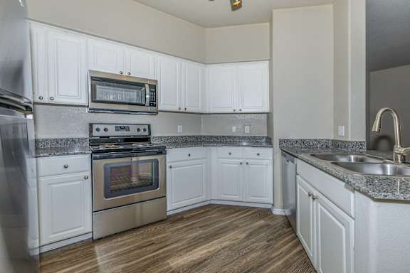 an empty kitchen with white cabinets and stainless steel appliances at The Aliante by Picerne, Scottsdale, 85259
