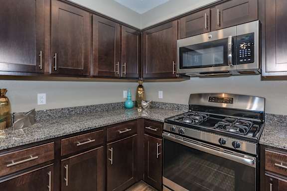 a kitchen with granite counter tops and stainless steel appliances