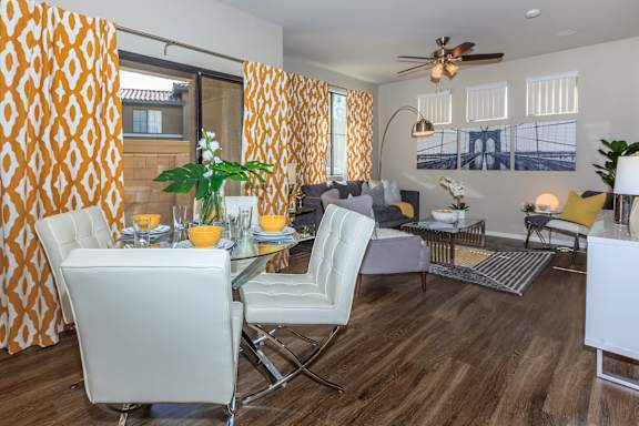 a living room and dining room with a table and chairs at The Preserve by Picerne, N Las Vegas, Nevada