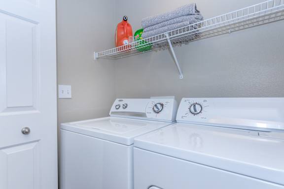 Laundry room with washer and dryer and a shelf at The Presidio by Picerne, N Las Vegas, NV