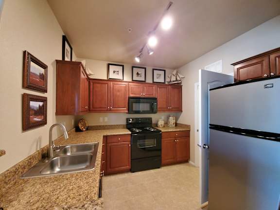 a kitchen with stainless steel appliances and granite counter tops at The Paramount by Picerne, Nevada, 89123