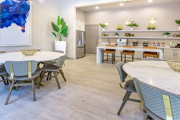a dining room with tables and chairs and a kitchen at The Preserve by Picerne, Nevada