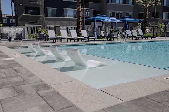 Swimming Pool With Lounge Chairs at Level 25 at The Curve by Picerne, Nevada
