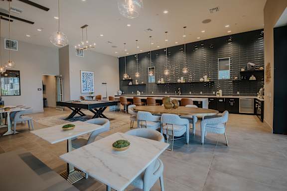 Resident clubhouse with pool table, fire place, lounge seating, long bar at Level 25 at The Curve by Picerne, Las Vegas, 89148