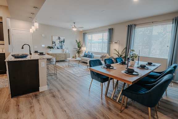 A modern kitchen with a dining table set for six.