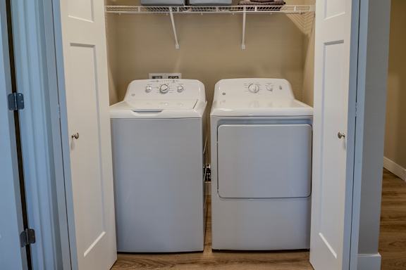 Front loading washing machines in a small laundry room at Level 25 at The Curve by Picerne, Nevada , 89148