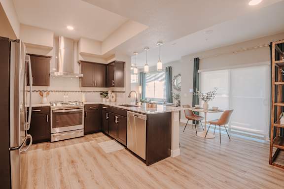 Modern kitchen with wooden floors at Level 25 at The Curve by Picerne, Las Vegas, Nevada
