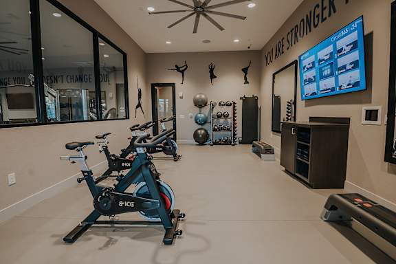 Spacious fitness center with cardio machines and weights at Level 25 at The Curve by Picerne, Nevada , 89148