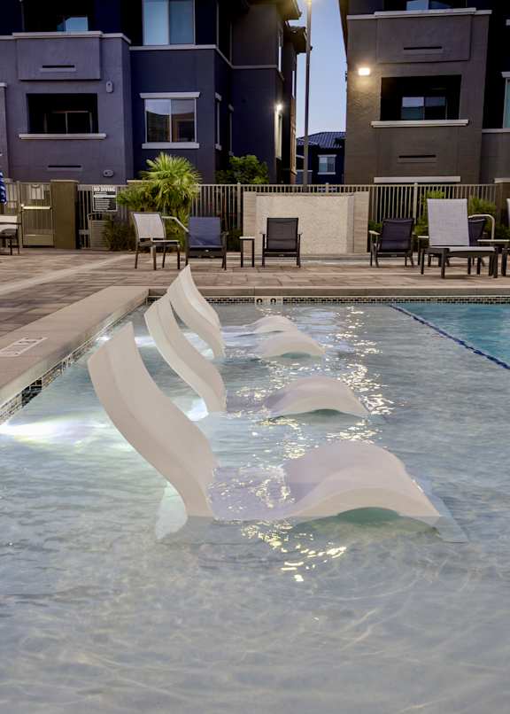 Shallow water sundeck with tanning chairs in swimming water at Level 25 at The Curve by Picerne, Nevada , 89148