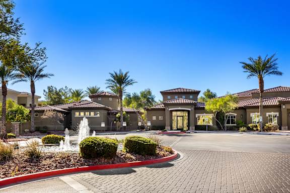 A building with a fountain in front of it.