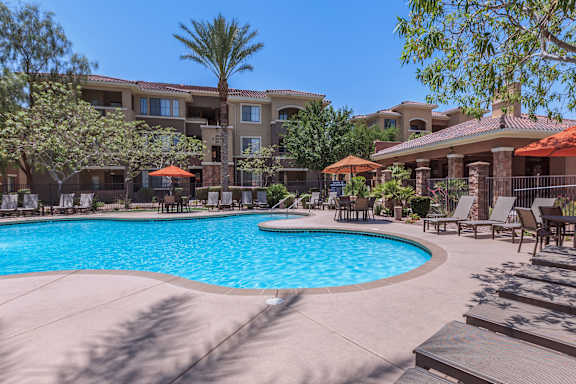 Swimming Pool Area With Shaded Chairs at The Presidio by Picerne, Nevada , 89084