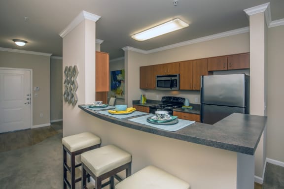 a kitchen with a counter top and a sink and a refrigerator at Loreto & Palacio Apartments, Las Vegas, NV