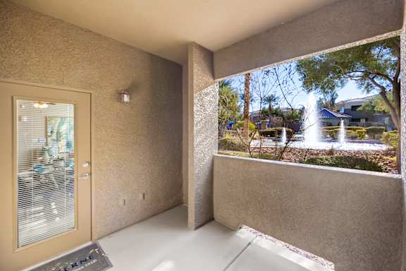 A view of a courtyard from a window in a room.