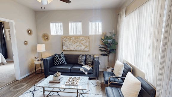 A living room with a grey couch and a coffee table.
